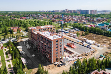 Fototapeta premium the construction site of an apartment building in the summer from a height