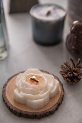 Candle in the shape of a peony flower on the table