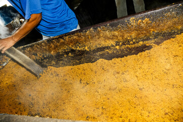Sugar cane juice boiling in artisanal clay ovens to produce brown sugar and candies. Alexânia,...