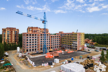 Fototapeta premium the construction site of an apartment building in the summer from a height