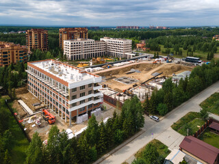 Fototapeta premium the construction site of an apartment building in the summer from a height
