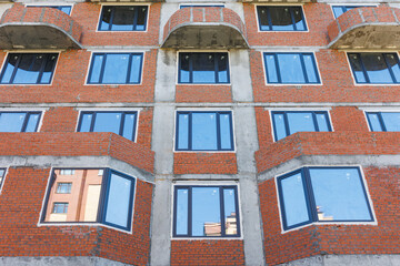 the construction site of an apartment building in the summer from a height