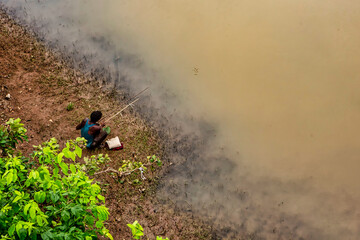 Village boy enjoying fishing at Ken River in Kajuraho, Madhya Pradesh