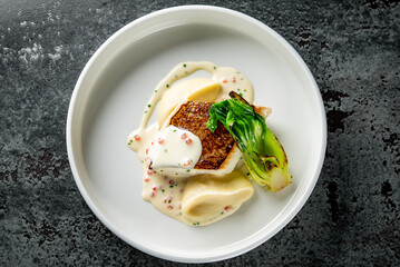 Fried fillet dorado fish with mushed potato and sauce