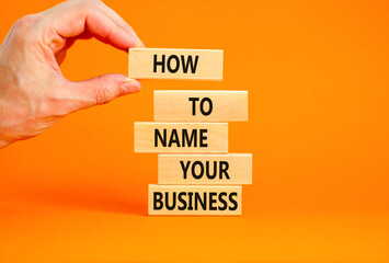 How to name your business symbol. Concept words How to name your business on wooden blocks. Beautiful orange table orange background. Businessman hand. How to name your business concept. Copy space.