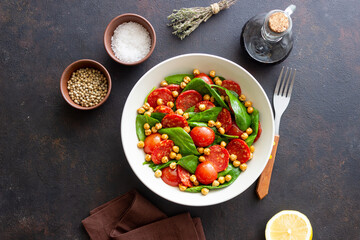 Salad with spinach, sausage, tomatoes and chickpeas. Healthy eating. Diet.