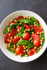 Salad with spinach, sausage, tomatoes and chickpeas. Healthy eating. Diet.