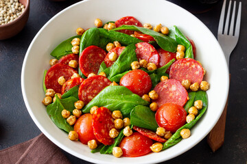 Salad with spinach, sausage, tomatoes and chickpeas. Healthy eating. Diet.