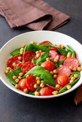 Salad with spinach, sausage, tomatoes and chickpeas. Healthy eating. Diet.