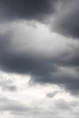 Fototapeta premium Black clouds in bright blue sky closeup