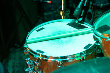 Drum kit in green light close up