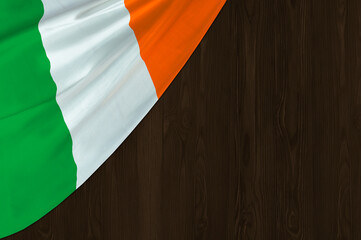 Ireland flag in corner on wooden background