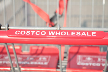 costco wholesale red silver shopping cart close up on costco wholesale writing caption text on...