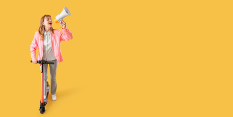 Portrait of screaming businesswoman with megaphone and kick scooter on yellow background with space...