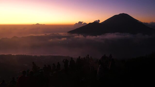 Tourists watching the sunrise on top of Batur volcano in Bali, Indonesia