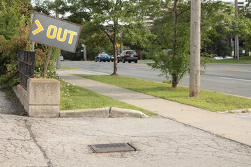 out word caption text horizontal gray yellow crooked out sign exit entrance to store parking lot...