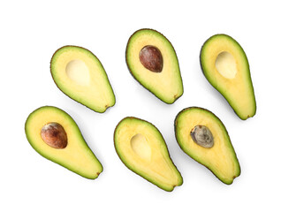 Halves of tasty ripe avocados on white background