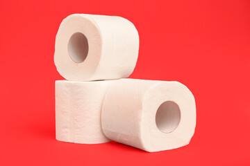 Rolls of toilet paper on red background