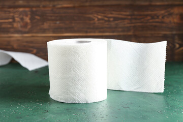 Roll of toilet paper on green table