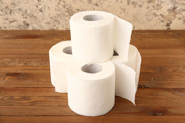 Rolls of toilet paper on wooden table