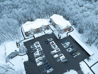 aerial view of apartment building community after snow