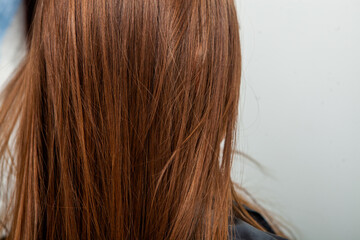 Photo of a European girl with long and beautiful brunette hair at the beauty salon. Shiny and healthy hair