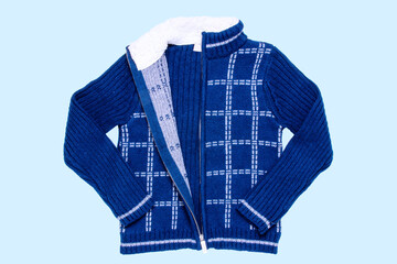 Autumn and winter jacket. A dark blue woolen knitted cardigan or pullover with a white checkered...