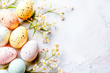 Easter background with colorful eggs, flowers and copy space