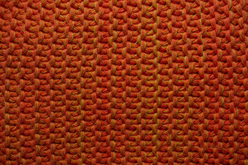 Knitted orange bright background close-up. Template design.