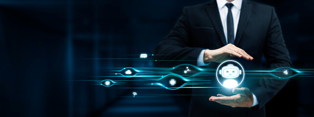 Chatbot, Businessman Holding Chatbot icon, Conversational AI, Automated Assistance, Virtual Interaction on Dark Background.