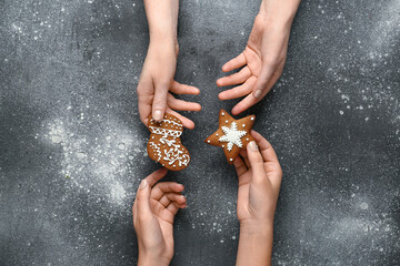 Female hands with sweet Christmas cookies on grunge background