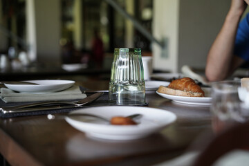 A person is enjoying the hotel breakfast and eating at the restaurant. An adult is eating breakfast...