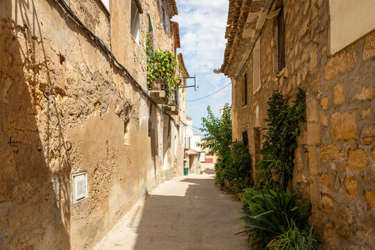 a narrow street with traditional architecture in Fabara - Favara, province of Zaragoza, Aragon, Spain