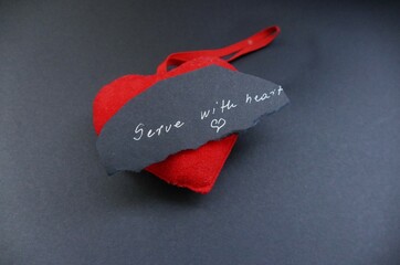 Serve with heart - heart and note with handwriting text - obrazy, fototapety, plakaty