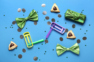 Composition with rattles, bows and Hamantaschen cookies for Purim celebration on color background