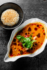 pan asian food. Tom Yum soup in bowl on table background