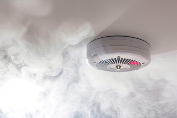 Home safety - smoke detector on ceiling detecting house fire