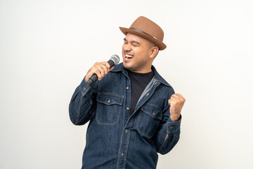 Happiness young asian man singing song. Artist vocalist singer on isolated background. Confident man public speaking talking with microphone in studio.