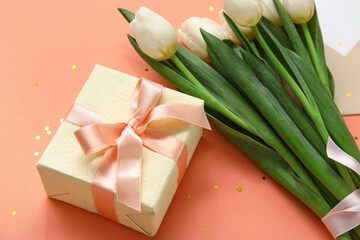 White tulips with gift box and confetti on orange background