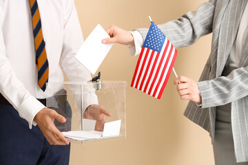 Woman with USA flag putting voting paper into ballot box on beige background. Election concept