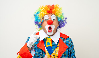 Mr Clown. Portrait of Funny comedian face Clown man in colorful uniform wearing wig standing...