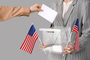 Hand putting voting paper into ballot box on white background. Election concept