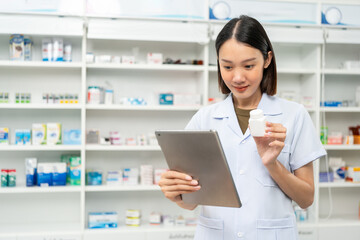 Obraz na płótnie Canvas Professional Pharmacist woman in uniform holding medicine bottle talks to patient via online video conferencing advice to customers standing near drug shelves counter. Pharmacist inventory medicine