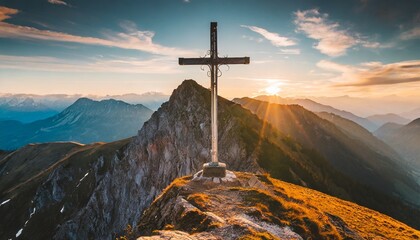 mountain summit cross on alpine peak at sunset