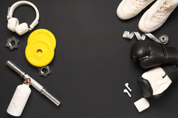 Composition with sports equipment and headphones on dark background