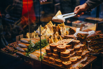 Different kinds of turkish traditional desserts and eastern sweets on sale at one of the markets in istanbul, Turkey.