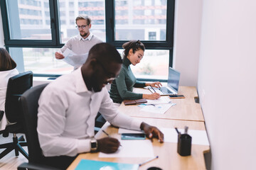Fototapeta premium Diverse colleagues working on project in office