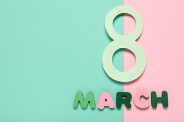 Paper figure 8 and word MARCH on colorful background. International Women's Day celebration