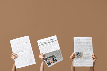 Women with newspapers on brown background