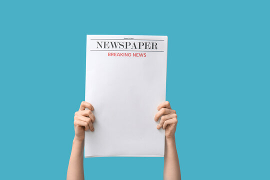 Woman with blank newspaper on blue background